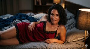 Elegant mature woman in silk slip dress lounging in a penthouse, evoking sophisticated MILF dating glamour